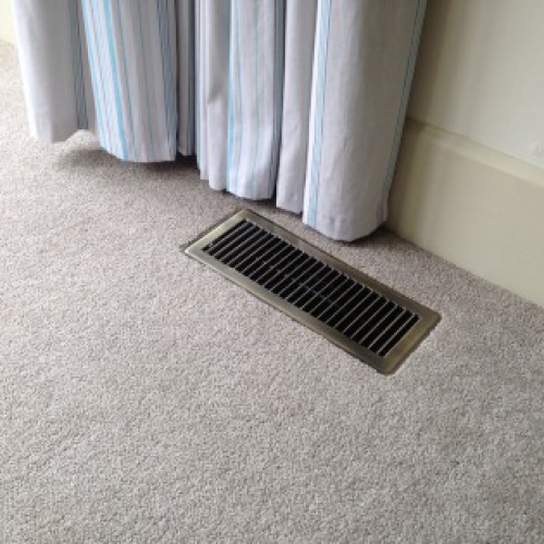 Metal grill installed in carpet